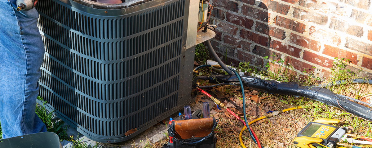 HVAC repairman fixing air conditioner